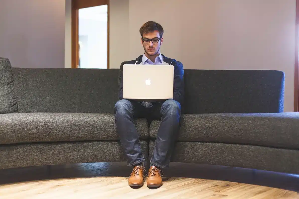 Anonyme Silhouetten an einem Laptop in einem Büro, Ausdrucke auf dem Tisch