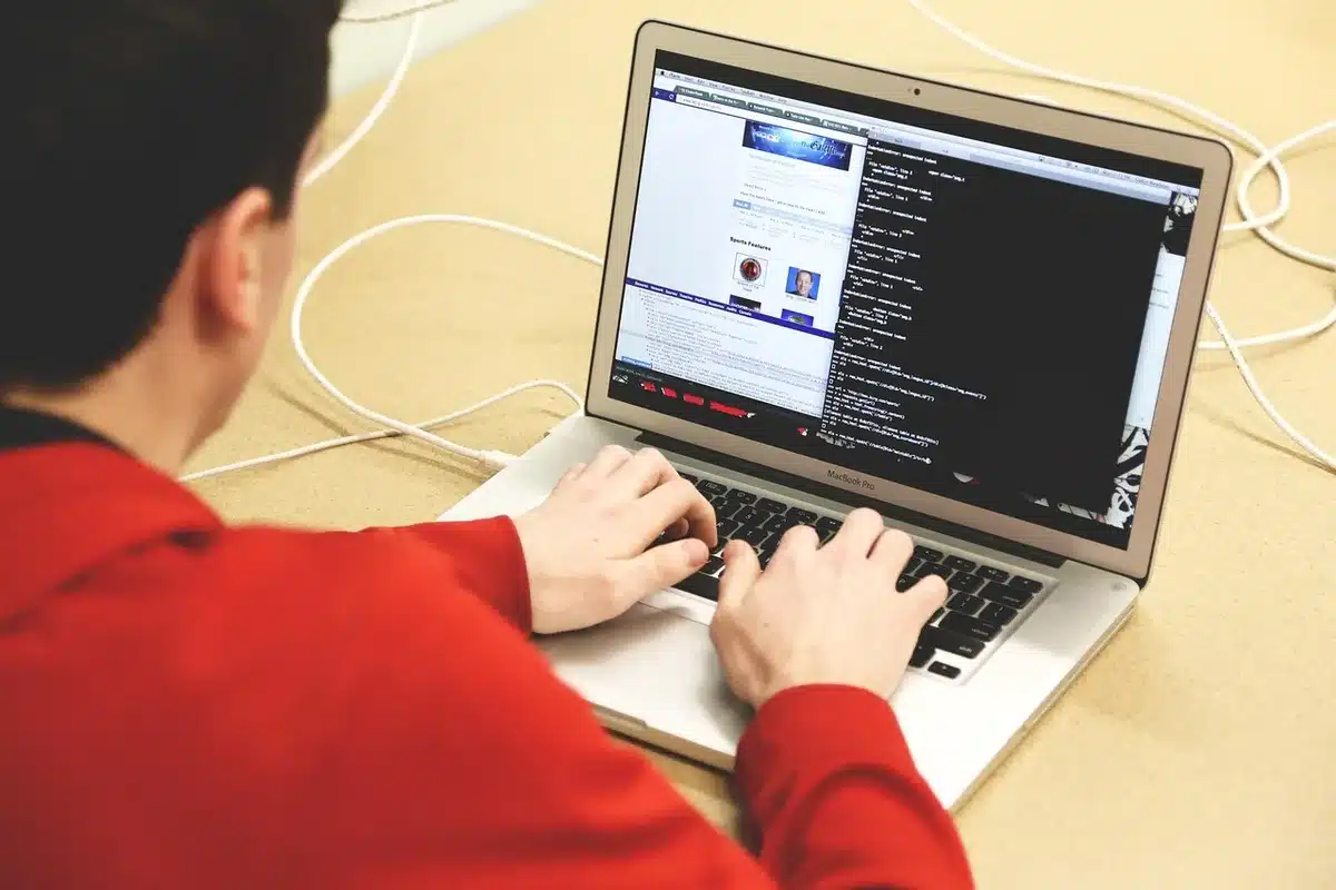 Studierende in einem Informatik-Klassenraum arbeiten am Laptop